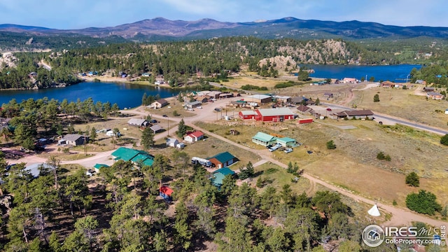 aerial view with a forest view and a water and mountain view