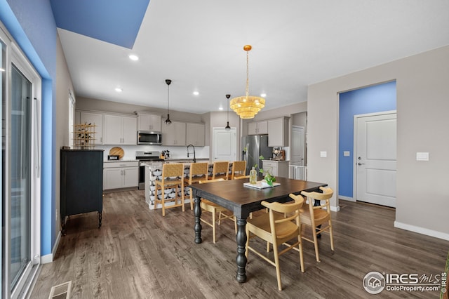 dining space with visible vents, recessed lighting, baseboards, and wood finished floors