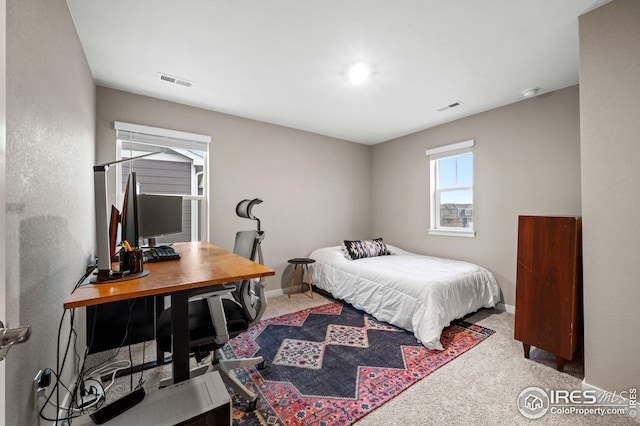 bedroom with visible vents, baseboards, and carpet flooring