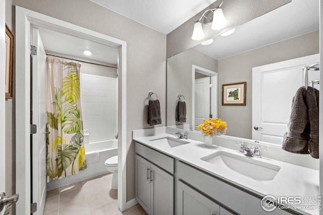 full bathroom with a sink, shower / bath combo with shower curtain, toilet, and double vanity