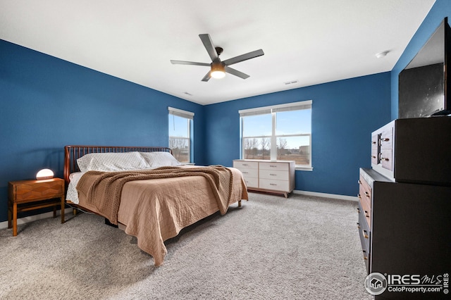 bedroom featuring ceiling fan, baseboards, visible vents, and light carpet