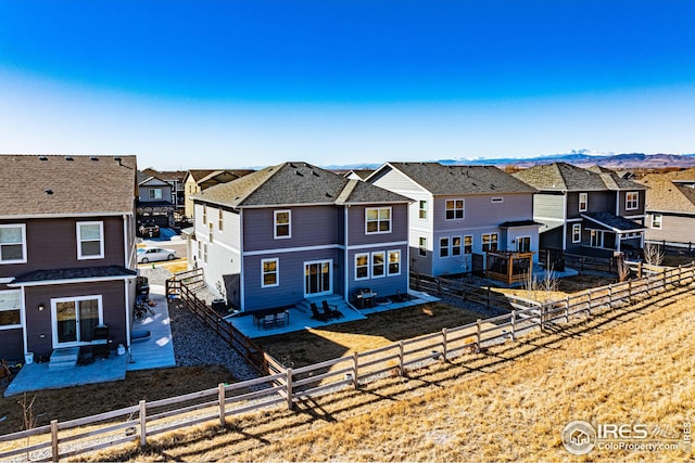 back of property featuring a patio area, a residential view, and fence private yard