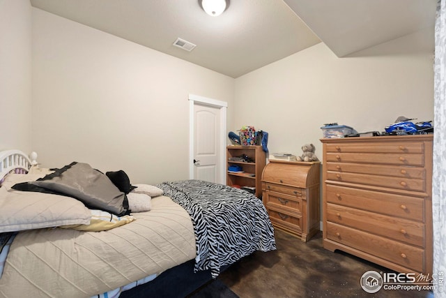 bedroom with visible vents and concrete flooring