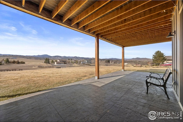 view of patio / terrace featuring a rural view and a mountain view