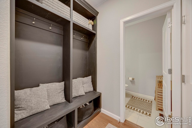 mudroom with baseboards and light wood-style floors