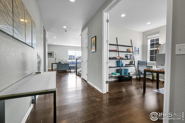 interior space with recessed lighting, a textured wall, and hardwood / wood-style floors