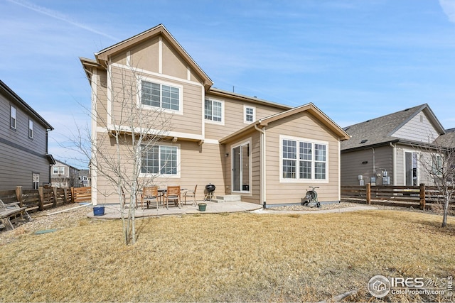 back of house featuring a patio, a lawn, and a fenced backyard