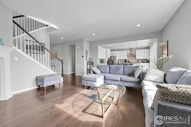 living area featuring stairway, recessed lighting, wood finished floors, and baseboards