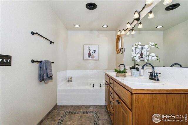 full bathroom with vanity, a bath, recessed lighting, and tile patterned flooring