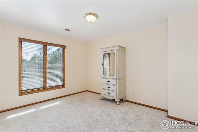 interior space with light carpet and baseboards