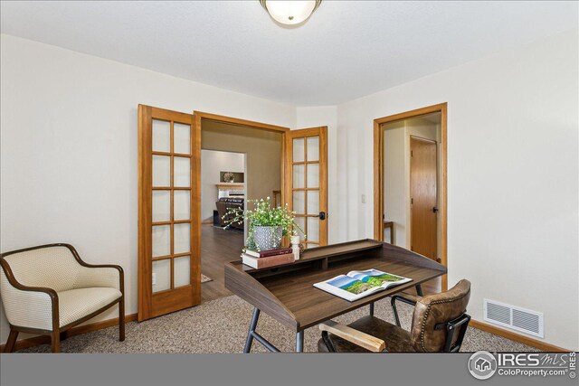 carpeted home office with visible vents, french doors, and baseboards