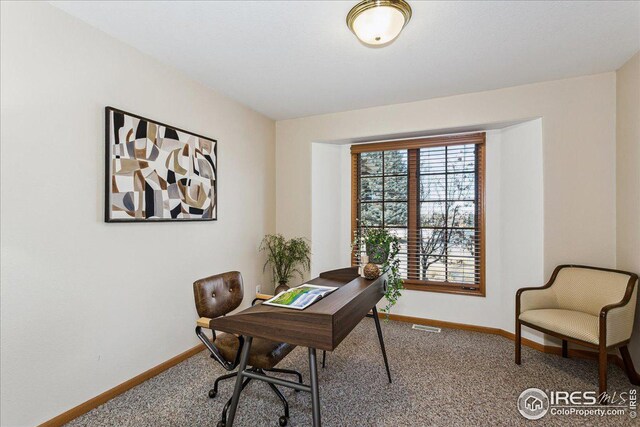 home office with visible vents, carpet floors, and baseboards