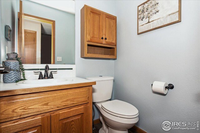 half bath with vanity and toilet