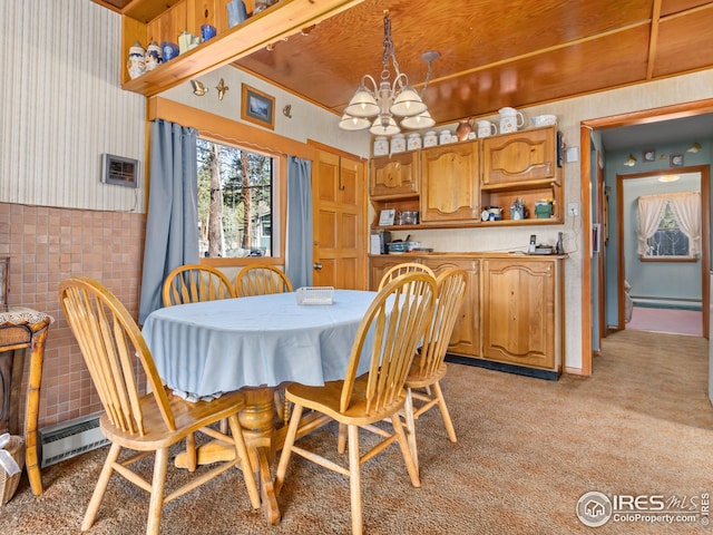 dining room featuring a baseboard heating unit, an inviting chandelier, light colored carpet, and a baseboard radiator