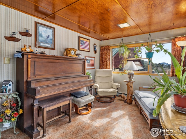 living area with wood ceiling, carpet, and a mountain view