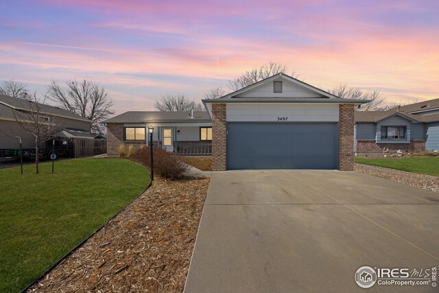 ranch-style house with brick siding, a front lawn, concrete driveway, and a garage