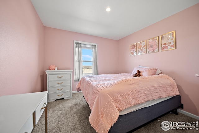 bedroom with carpet flooring and baseboards