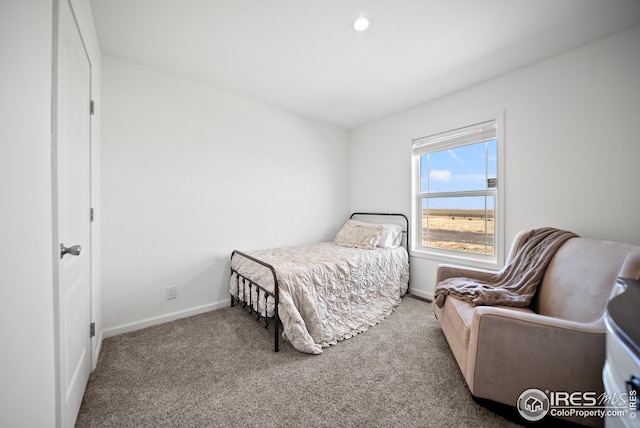 carpeted bedroom featuring baseboards