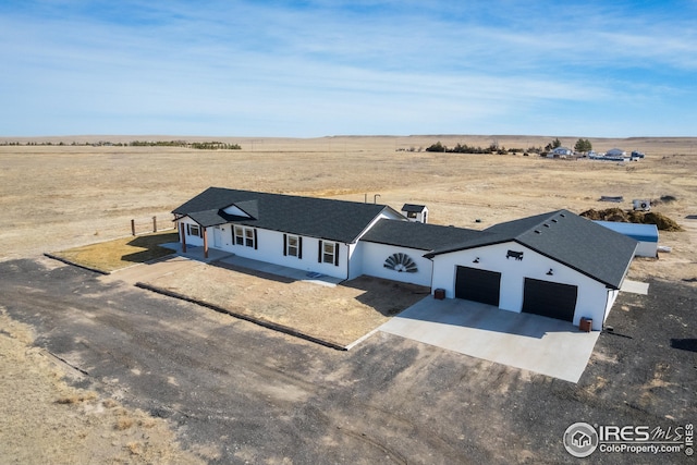 view of front of property featuring a rural view and dirt driveway