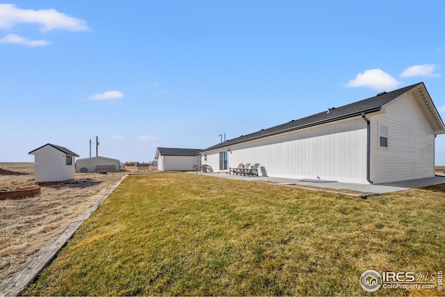 back of property featuring a patio and a lawn