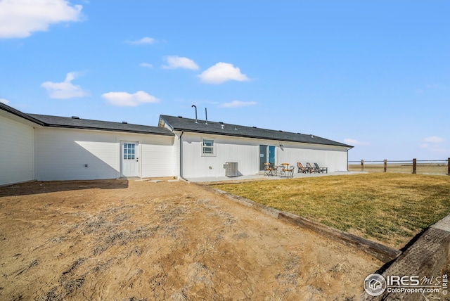 rear view of house with a yard, central air condition unit, a patio, and fence