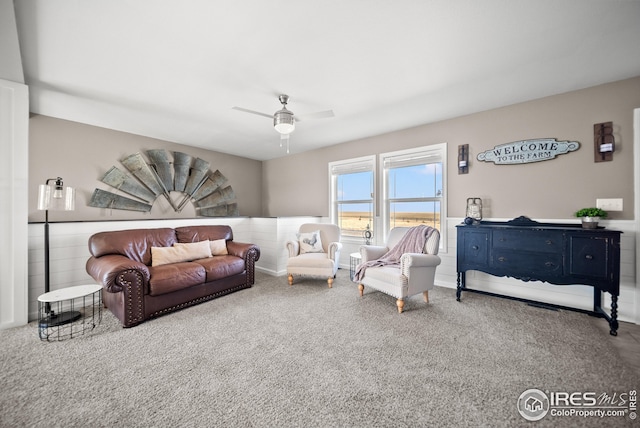 carpeted living area featuring a ceiling fan