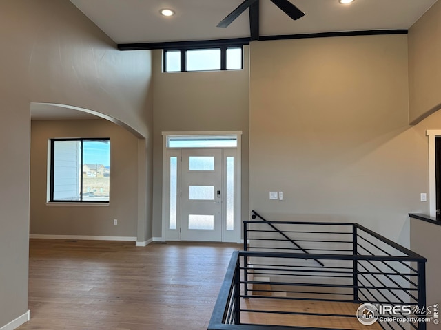 entrance foyer featuring recessed lighting, baseboards, a high ceiling, and wood finished floors