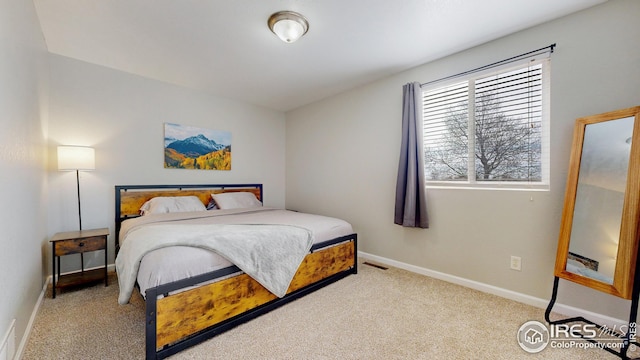 carpeted bedroom featuring visible vents and baseboards