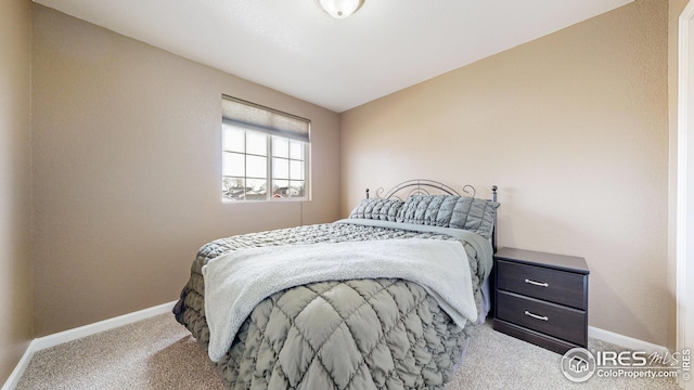 carpeted bedroom featuring baseboards