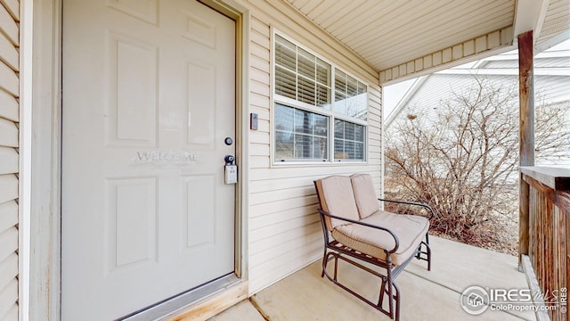 view of exterior entry with a porch