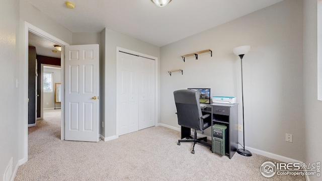 carpeted office space with baseboards