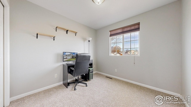 carpeted office with visible vents and baseboards