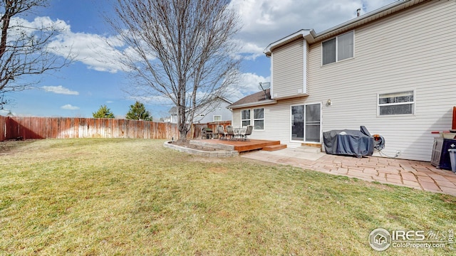 view of yard featuring a patio area, a wooden deck, and fence private yard