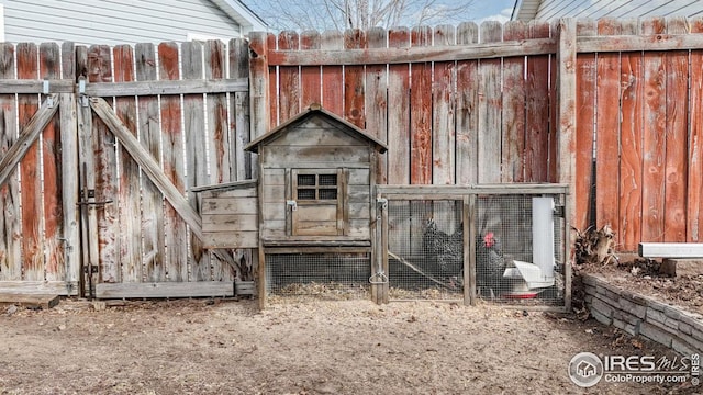 view of outbuilding featuring an outdoor structure and fence