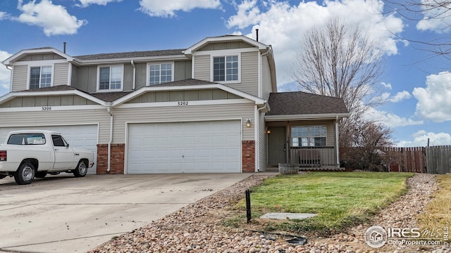 view of front of home featuring driveway, fence, roof with shingles, board and batten siding, and brick siding