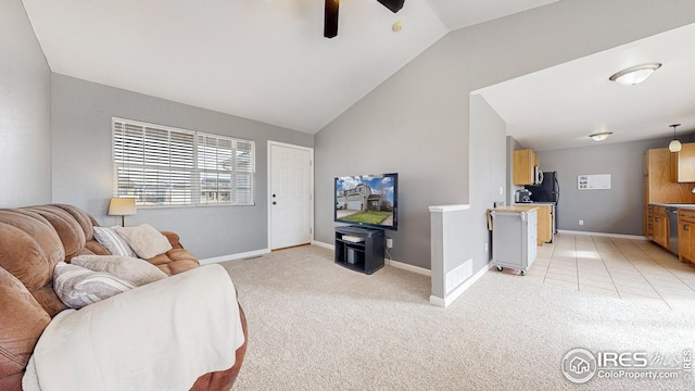 living room with a ceiling fan, vaulted ceiling, light colored carpet, and baseboards