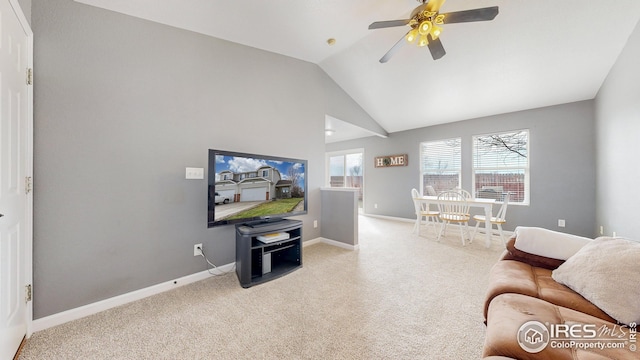 carpeted living room with high vaulted ceiling, baseboards, and ceiling fan