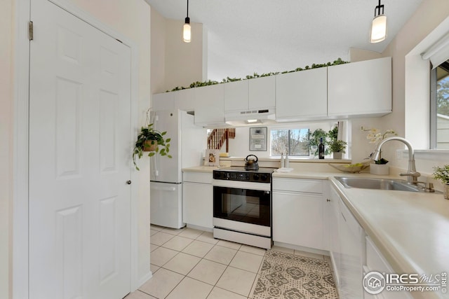 kitchen with white appliances, light tile patterned floors, a sink, light countertops, and under cabinet range hood