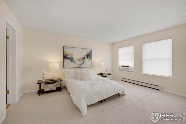 bedroom featuring a baseboard heating unit, baseboards, carpet floors, cooling unit, and a textured ceiling