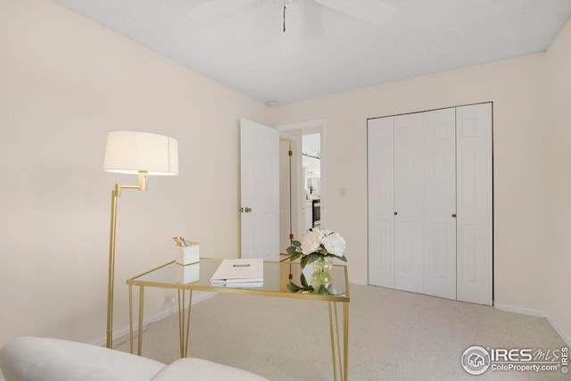 carpeted office with baseboards and ceiling fan