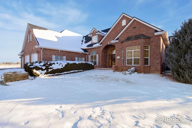 view of front facade featuring a garage and brick siding