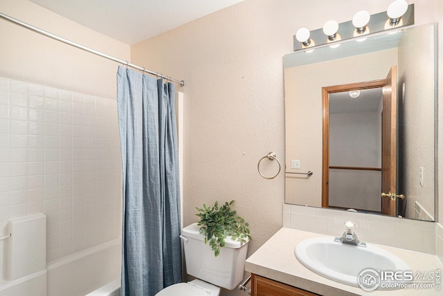 full bath featuring a textured wall, toilet, vanity, and shower / bath combination with curtain