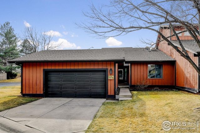 view of front facade with board and batten siding, a shingled roof, concrete driveway, a front yard, and a garage