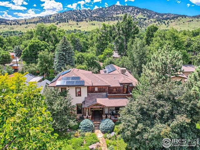 drone / aerial view featuring a forest view and a mountain view