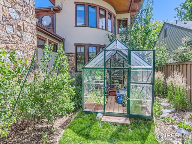 view of greenhouse featuring fence