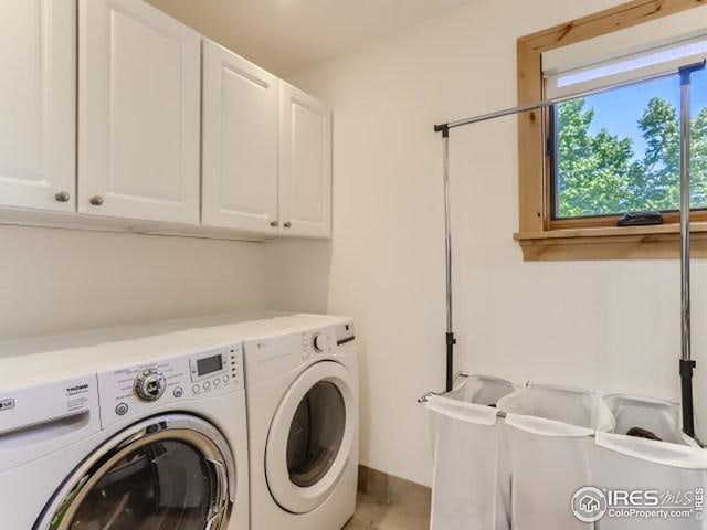 laundry area with cabinet space and separate washer and dryer