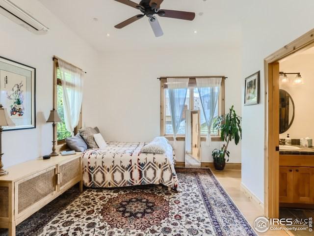 bedroom featuring recessed lighting, multiple windows, ensuite bath, and a wall unit AC