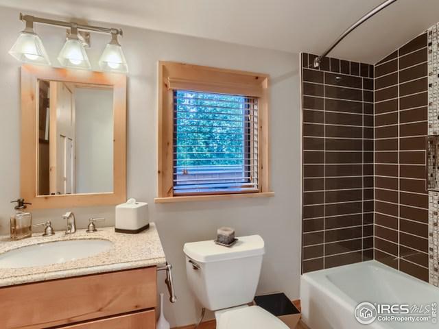 bathroom with vanity, bathing tub / shower combination, and toilet
