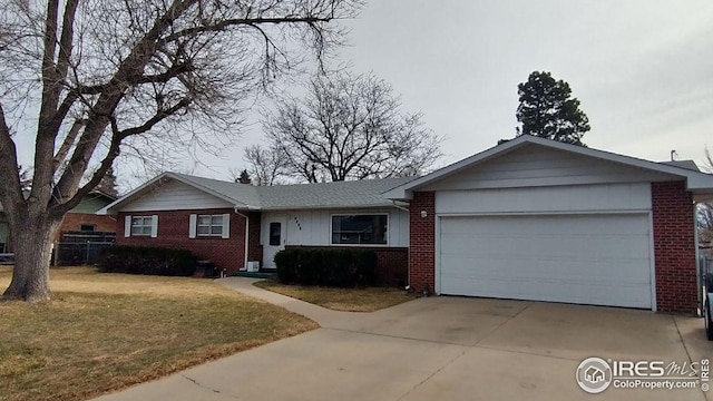 ranch-style house featuring brick siding, an attached garage, driveway, and a front yard