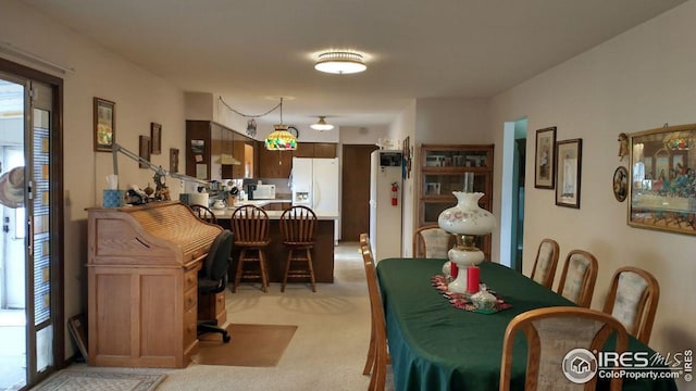 dining room with light carpet